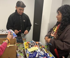 Volunteers pack goodie bags for a community outreach event during domestic violence awareness month